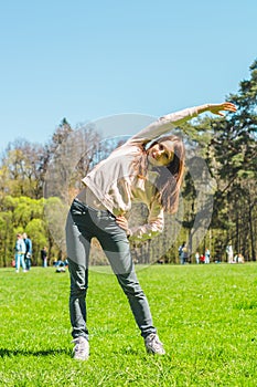 Young woman doing sports outdoors. Sport and lifestyle concept. tilt to the left, front view