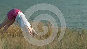 Young woman doing sports outdoors, yoga