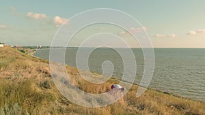 Young woman doing sports outdoors, yoga. aerial video