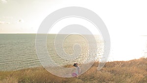 Young woman doing sports outdoors, yoga. aerial video