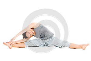 Young woman doing stretch exercise on floor