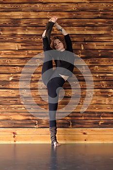 Young woman doing a stretching exercise Utthita Hasta Padangusthasana pose