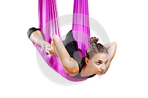 Young woman doing stretching. Fitness, stretch, balance, exercise and healthy lifestyle people. Woman using hammock.