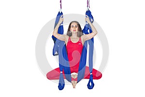 Young woman doing stretching. Fitness, stretch, balance, exercise and healthy lifestyle people. Woman using hammock