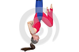 Young woman doing stretching. Fitness, stretch, balance, exercise and healthy lifestyle people. Woman using hammock