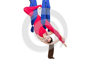 Young woman doing stretching. Fitness, stretch, balance, exercise and healthy lifestyle people. Woman using hammock