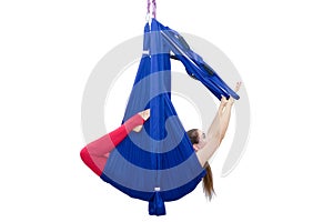 Young woman doing stretching. Fitness, stretch, balance, exercise and healthy lifestyle people. Woman using hammock