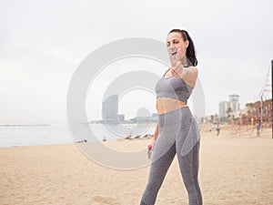 young woman doing stretching at Playa de la Barceloneta - Barcelona Spain.