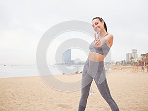 young woman doing stretching at Playa de la Barceloneta - Barcelona Spain.