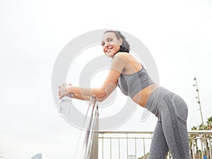 young woman doing stretching at Playa de la Barceloneta - Barcelona Spain. photo