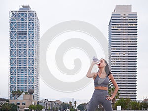 young woman doing stretching at Playa de la Barceloneta - Barcelona Spain. photo