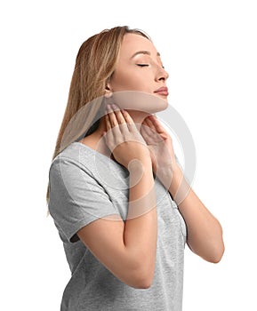 Young woman doing thyroid self examination on white background