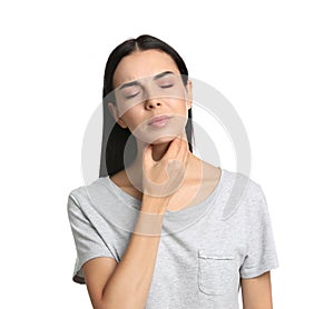 Young woman doing thyroid self examination on white background