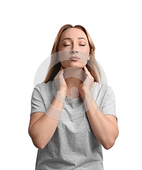 Young woman doing thyroid self examination on white background