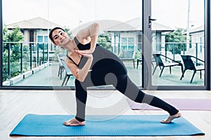 Young woman doing twist pose yoga