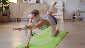 Young woman doing workout at home. Caucasian woman doing bodyweight exercises on yoga mat
