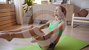 Young woman doing workout at home. Caucasian woman doing bodyweight exercises on yoga mat