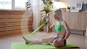 Young woman doing workout at home. Caucasian woman doing bodyweight exercises on yoga mat