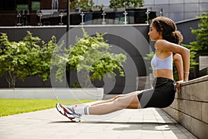 Young woman doing workout outdoors at street