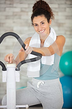 young woman doing workout on step machine