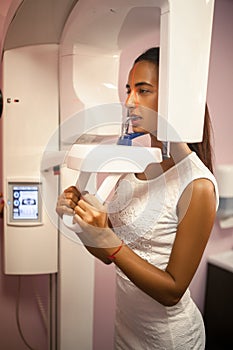 Young woman doing x-ray of teeth on x-ray machine.