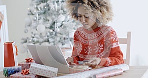 Young woman doing Xmas shopping online