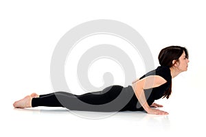 Young woman doing yoga asana Bhujangasana Cobra Pose