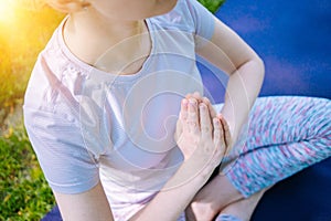 young woman doing yoga asana in park. girl stretching exercise in yoga position. happy and healthy woman sitting in