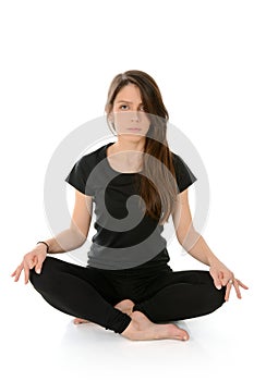 Young woman doing yoga asana Sukhasana easy sitting pose.