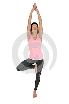 Young woman doing yoga asana Tree Pose or Vrksasana