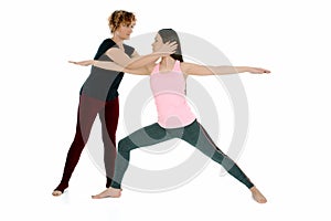 Young woman doing yoga asana Warrior Pose Virabradasana