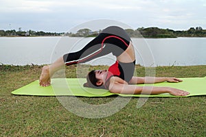 Young woman doing yoga exercise