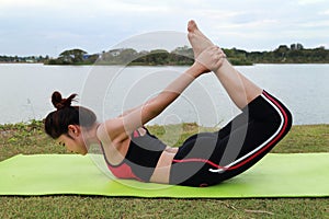 Young woman doing yoga exercise