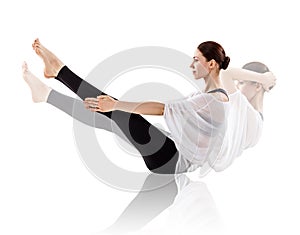 Young woman doing yoga exercise on the floor.