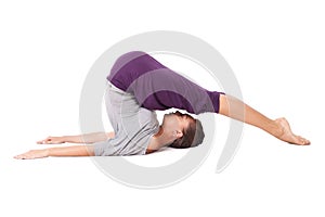 Young woman doing yoga exercise Halasana (Plow Pose). Isolated o photo