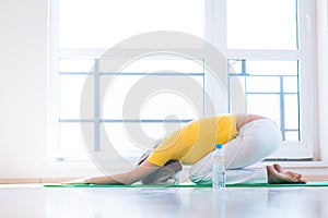 Young woman doing YOGA exercise at home