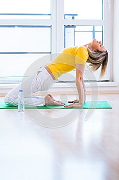 Young woman doing YOGA exercise at home