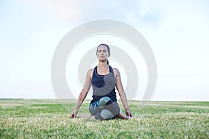 A Young woman doing yoga exercise outdoor