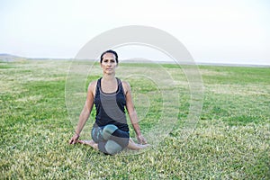 A Young woman doing yoga exercise outdoor