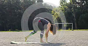 Young woman doing yoga exercise outdoors