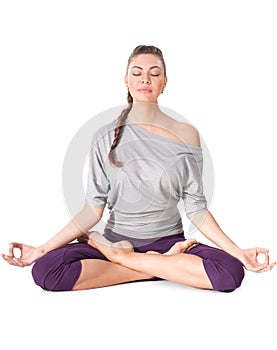 Young woman doing yoga exercise Padmasana (Lotus Pose). photo