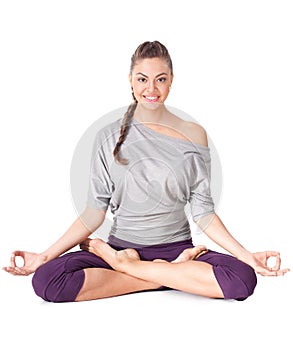 Young woman doing yoga exercise Padmasana (Lotus Pose).