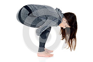 Young woman doing yoga exercise, squat position