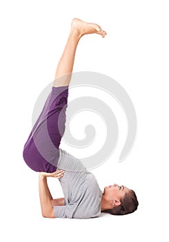 Young woman doing yoga exercise supported shoulderstand