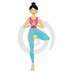 Young woman doing yoga exercise tree-pose