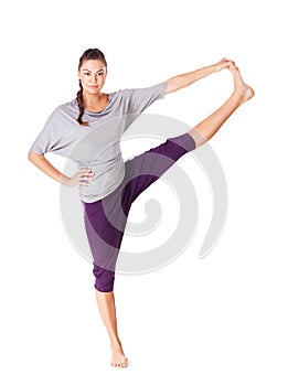 Young woman doing yoga exercise Utthita Hasta Padangustasana