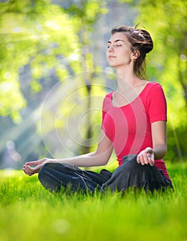 Young woman doing yoga exercises