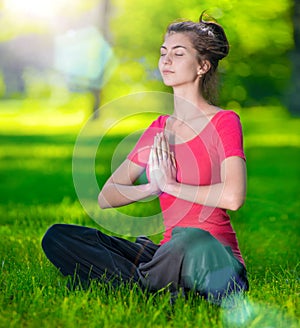 Young woman doing yoga exercises