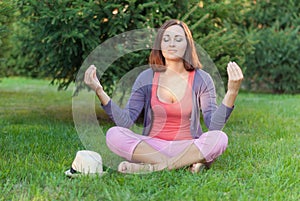 Young woman doing yoga exercises .