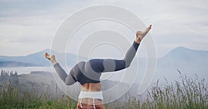 Young woman doing yoga exercises on fresh air